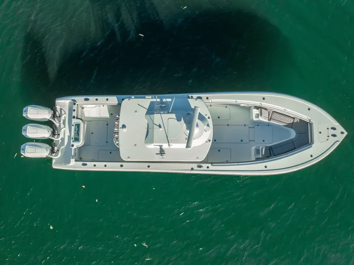  Yacht Photos Pics Aerial view of 2023 Yellowfin 36 boat on clear green water.