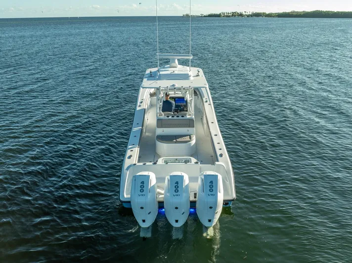  Yacht Photos Pics 2023 Yellowfin 36 boat with triple outboard engines on open water.