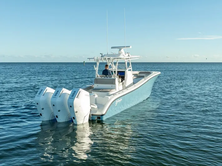  Yacht Photos Pics 2023 Yellowfin 36 boat with triple engines cruising on open water.