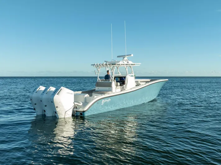  Yacht Photos Pics 2023 Yellowfin 36 boat with triple engines on calm ocean water.