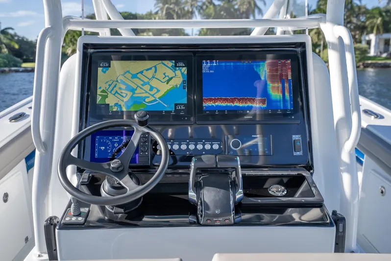  Yacht Photos Pics 2023 Yellowfin 36 boat dashboard with navigation screens and steering wheel.
