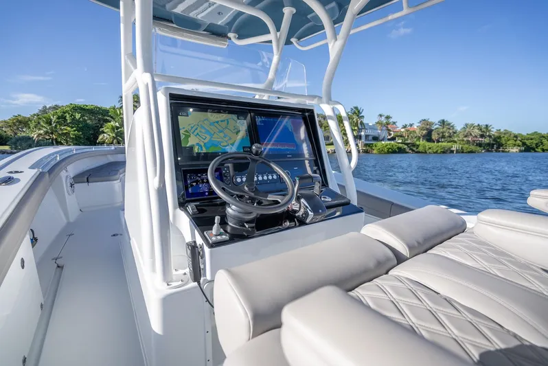  Yacht Photos Pics 2023 Yellowfin 36 boat cockpit with advanced navigation system on a sunny day.