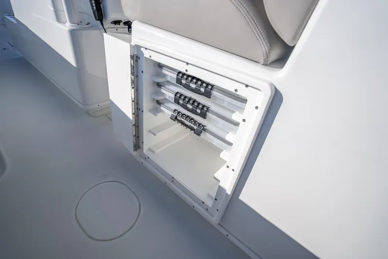  Yacht Photos Pics 2023 Yellowfin 36 boat storage compartment with rod holders and sleek design.