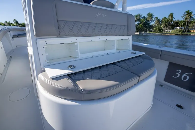  Yacht Photos Pics 2023 Yellowfin 36 boat interior with cushioned seating and storage compartment.
