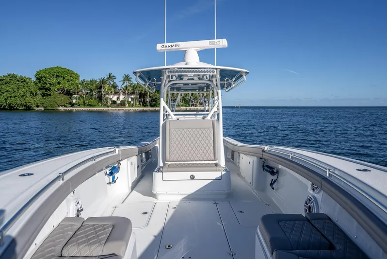  Yacht Photos Pics 2023 Yellowfin 36 boat on calm water, featuring spacious deck and modern design.