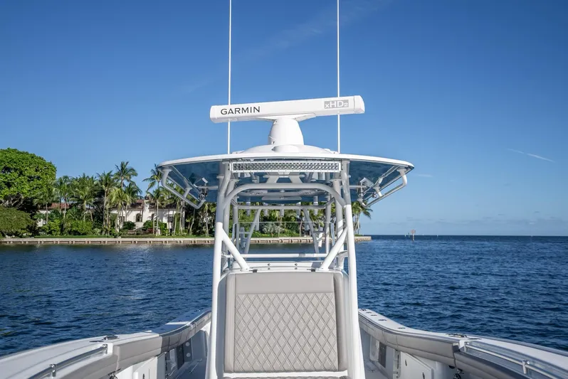  Yacht Photos Pics 2023 Yellowfin 36 boat on water, featuring Garmin radar, clear blue sky, and coastal scenery.