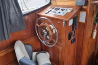 Interior of 1987 Zijlmans Kruiser boat with wooden helm and swivel chair.