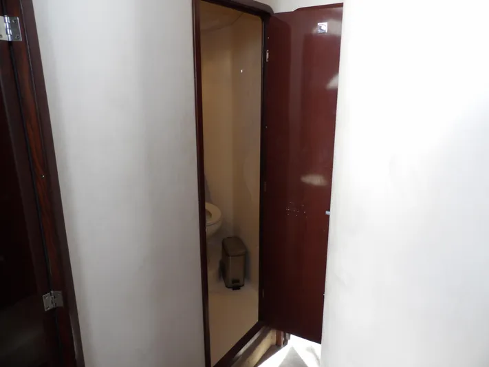  Yacht Photos Pics 2008 Sea Ray 44 Sedan Bridge bathroom interior with wooden door.