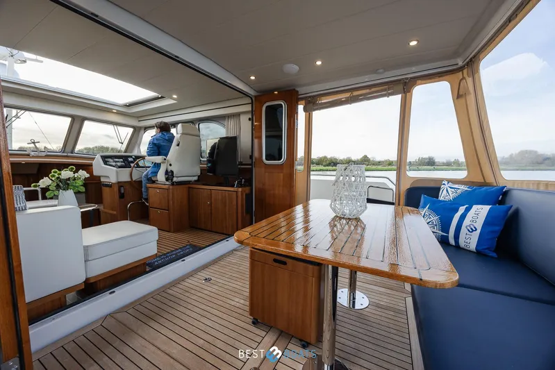  Yacht Photos Pics Interior of 2017 Linssen Grand Sturdy 470 Wheelhouse, featuring elegant wood finishes and seating.