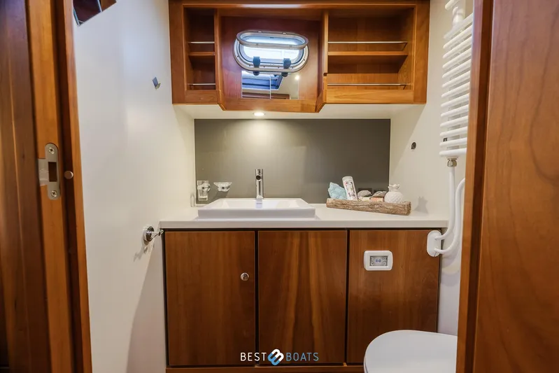  Yacht Photos Pics Luxurious bathroom in 2017 Linssen Grand Sturdy 470 Wheelhouse yacht, featuring wooden cabinetry.