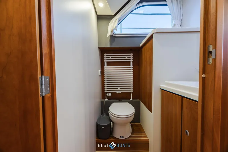 Yacht Photos Pics Bathroom interior of 2017 Linssen Grand Sturdy 470 Wheelhouse yacht, featuring wooden accents.