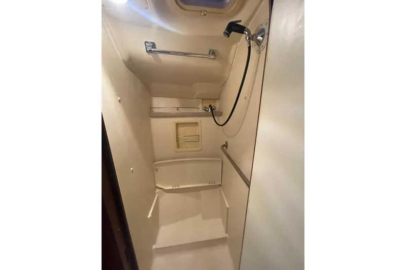  Yacht Photos Pics Compact shower area in a 1999 Hunter 460 sailboat, featuring a handheld showerhead.