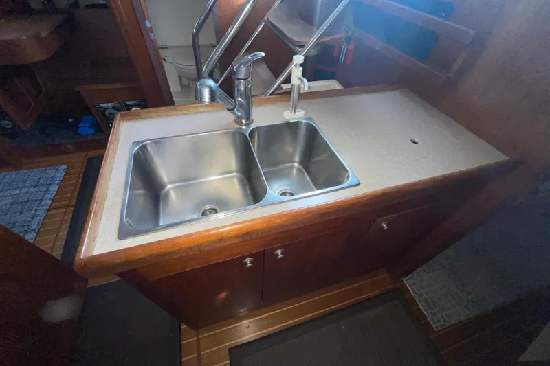  Yacht Photos Pics Double sink in 1999 Hunter 460 yacht kitchen with wooden cabinetry.