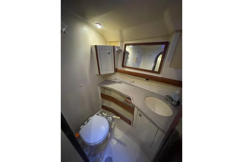  Yacht Photos Pics Bathroom interior of 1999 Hunter 460 yacht with sink, mirror, and toilet.