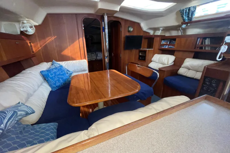  Yacht Photos Pics Interior of 1999 Hunter 460 yacht with cozy seating and wooden table.