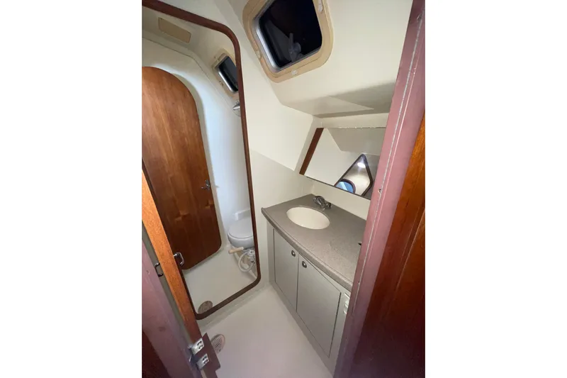 Yacht Photos Pics Bathroom interior of 1999 Hunter 460 yacht with sink and toilet.