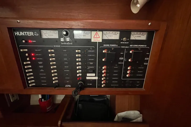  Yacht Photos Pics Electrical control panel of a 1999 Hunter 460 yacht, featuring various switches and meters.