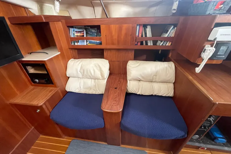  Yacht Photos Pics Cozy seating area in 1999 Hunter 460 yacht with bookshelves and communication equipment.