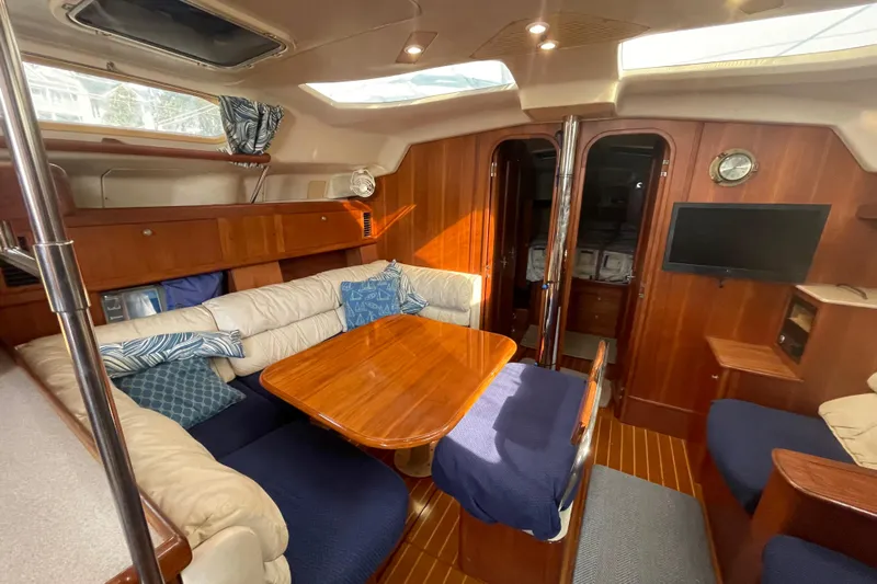  Yacht Photos Pics Interior of 1999 Hunter 460 yacht with cozy seating and wooden finishes.