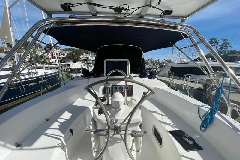  Yacht Photos Pics Cockpit view of 1999 Hunter 460 sailboat docked in a marina.