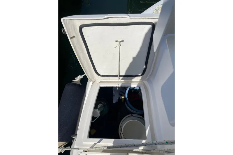  Yacht Photos Pics Open storage compartment on a 1999 Hunter 460 boat, showing interior contents.
