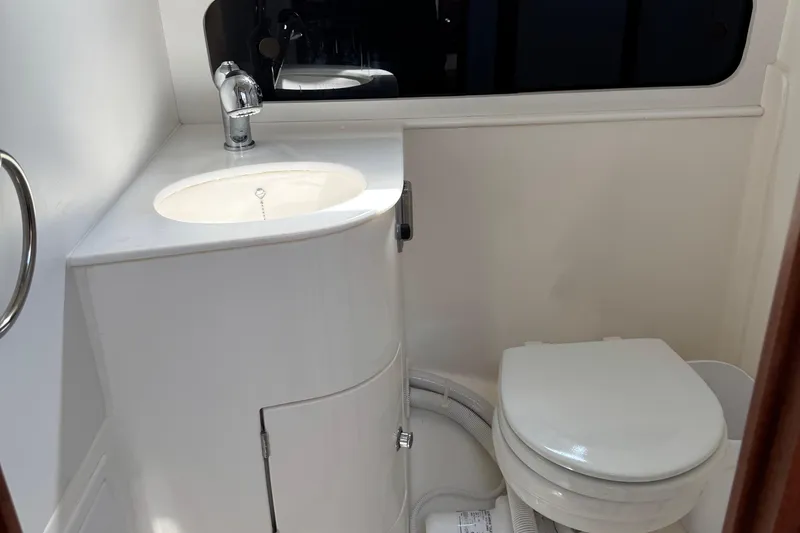  Yacht Photos Pics Modern bathroom in 2026 NorthCoast 285 HT boat, featuring sink and toilet.