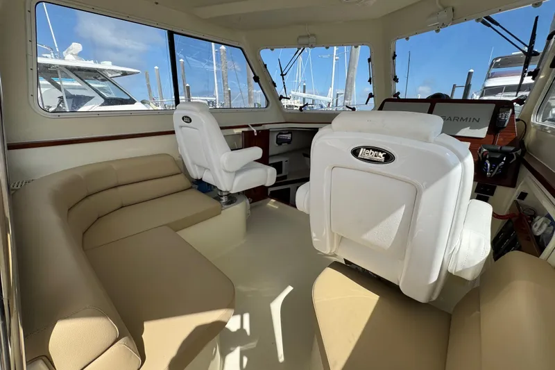  Yacht Photos Pics Interior of 2026 NorthCoast 285 HT boat with beige seating and helm station.