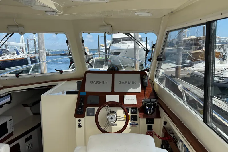 Yacht Photos Pics Interior view of 2026 NorthCoast 285 HT boat helm with Garmin navigation system.