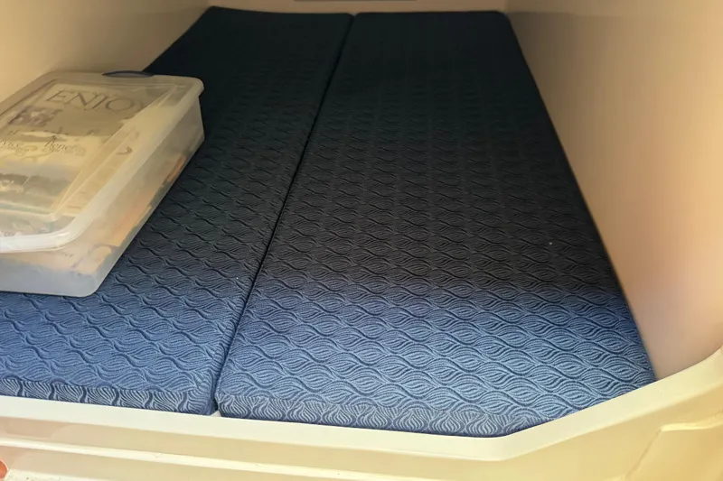  Yacht Photos Pics Cozy cabin interior of 2026 NorthCoast 285 HT with blue patterned cushions.
