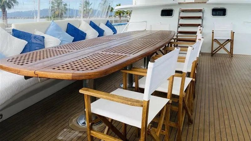  Yacht Photos Pics Luxurious deck of 2005 Explorer Motor Yachts 28M with wooden table and chairs.