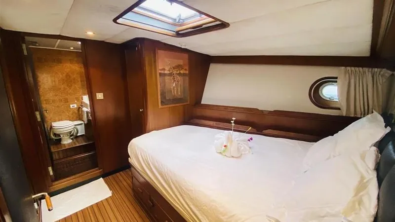  Yacht Photos Pics Luxurious bedroom in 2005 Explorer Motor Yachts 28M with ensuite bathroom and skylight.