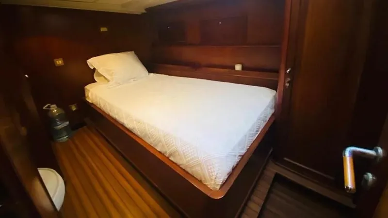  Yacht Photos Pics Cozy cabin interior of 2005 Explorer Motor Yachts 28M with wooden finish and single bed.