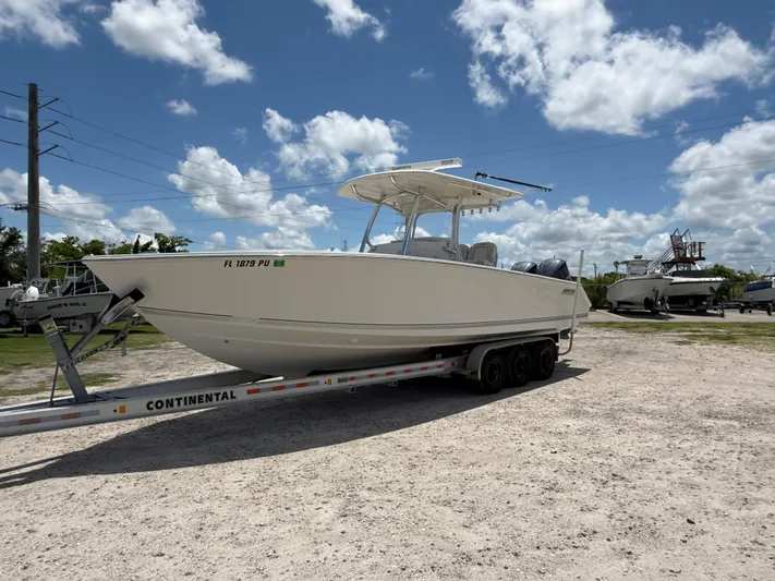  Yacht Photos Pics 2014 Jupiter 30 FS boat on trailer under cloudy sky.