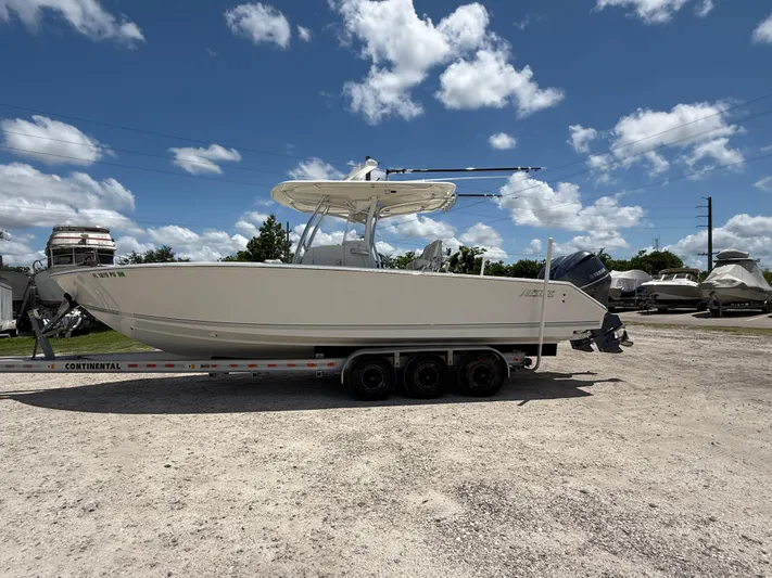  Yacht Photos Pics 2014 Jupiter 30 FS boat on trailer under blue sky with clouds.