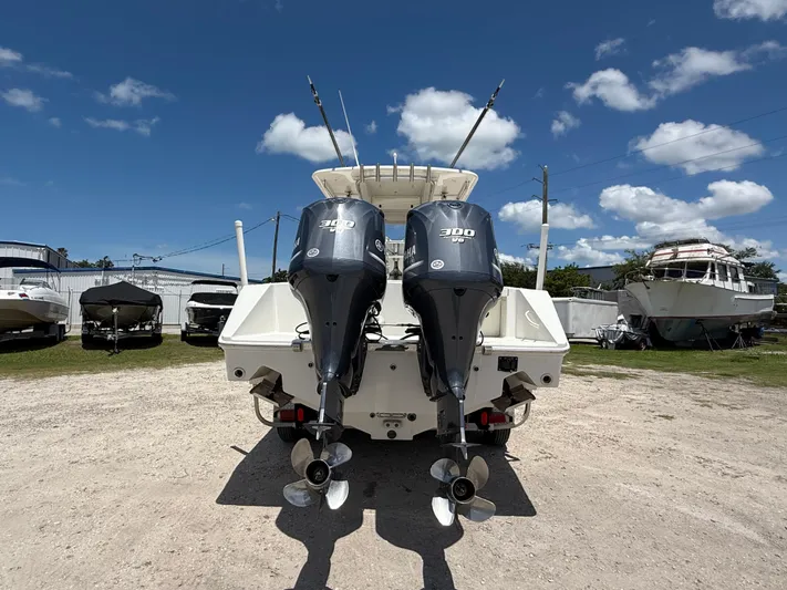  Yacht Photos Pics 2014 Jupiter 30 FS boat with dual 300 HP outboard engines, parked outdoors under blue sky.
