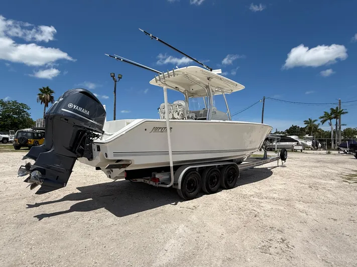  Yacht Photos Pics 2014 Jupiter 30 FS boat with Yamaha engine on a trailer, parked outdoors under a clear sky.