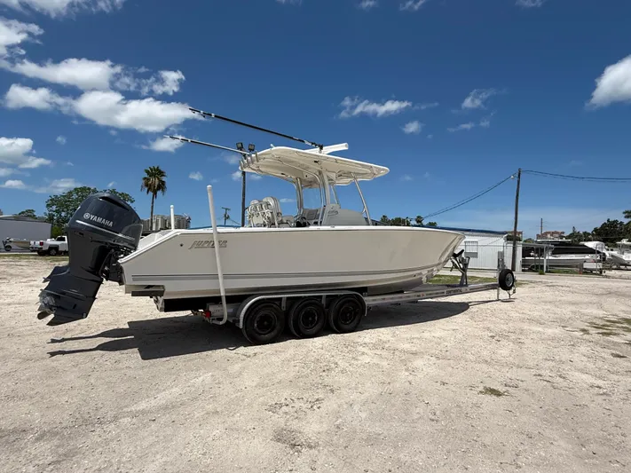  Yacht Photos Pics 2014 Jupiter 30 FS boat on trailer with Yamaha outboard, parked under clear blue sky.