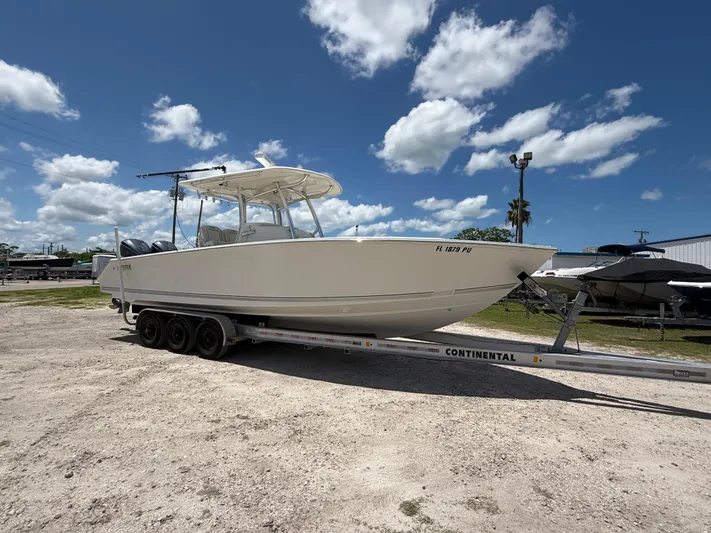  Yacht Photos Pics 2014 Jupiter 30 FS boat on trailer under blue sky with clouds.