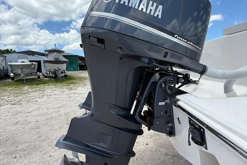  Yacht Photos Pics Outboard motor on a 2014 Jupiter 30 FS boat, parked outdoors under a cloudy sky.