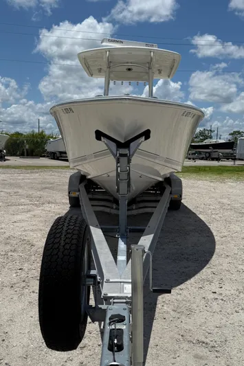  Yacht Photos Pics 2014 Jupiter 30 FS boat on trailer under a partly cloudy sky.
