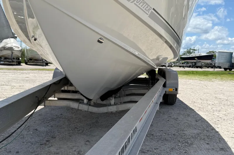  Yacht Photos Pics 2014 Jupiter 30 FS boat on trailer, parked outdoors under a clear blue sky.