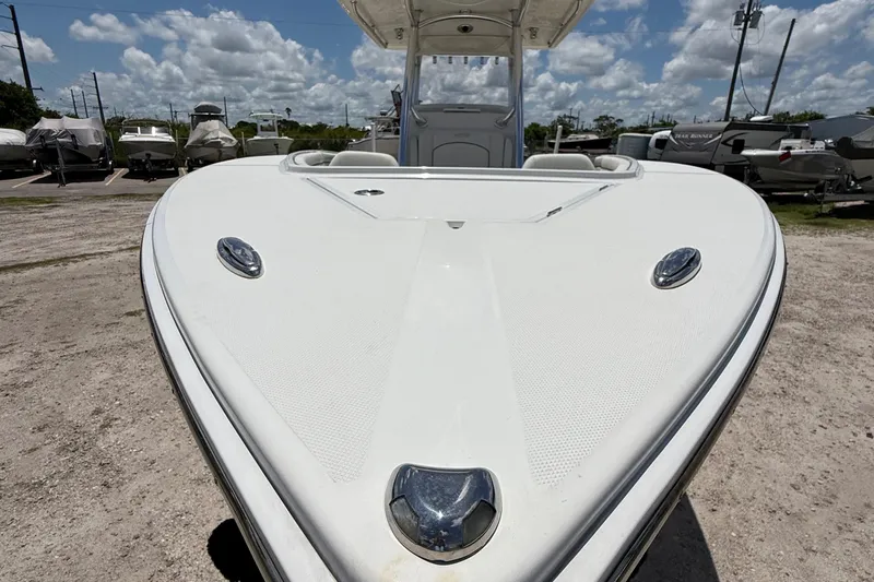  Yacht Photos Pics 2014 Jupiter 30 FS boat bow view under a cloudy sky in a boatyard.