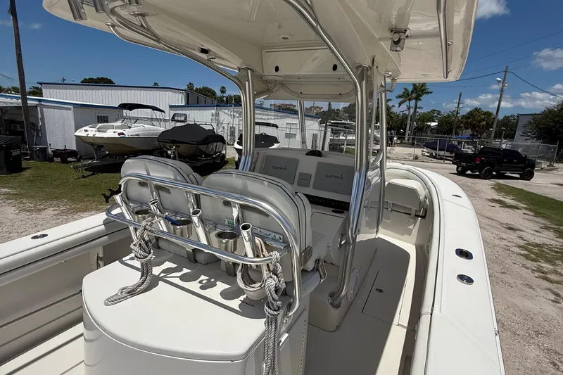 Yacht Photos Pics 2014 Jupiter 30 FS boat interior with helm, seats, and navigation equipment, parked outdoors.
