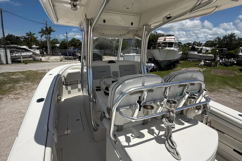  Yacht Photos Pics 2014 Jupiter 30 FS boat interior with seating and control panel, parked outdoors.