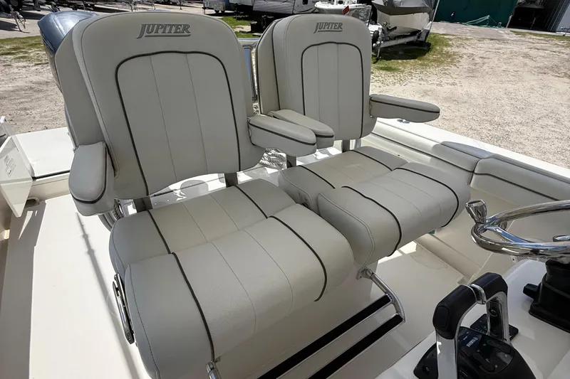  Yacht Photos Pics 2014 Jupiter 30 FS boat seats with armrests and steering wheel in a sunny outdoor setting.