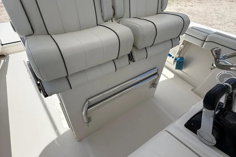  Yacht Photos Pics 2014 Jupiter 30 FS boat interior with white cushioned seats and control panel.