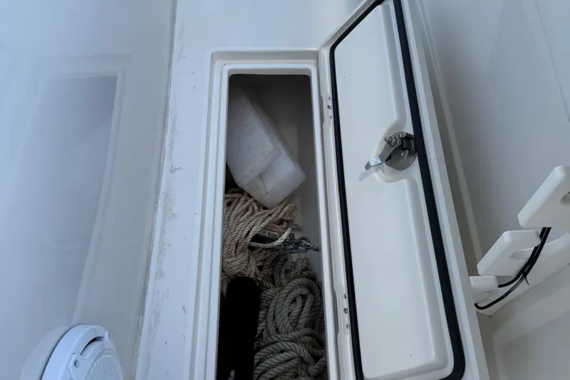  Yacht Photos Pics Storage compartment on a 2014 Jupiter 30 FS boat with ropes and equipment.