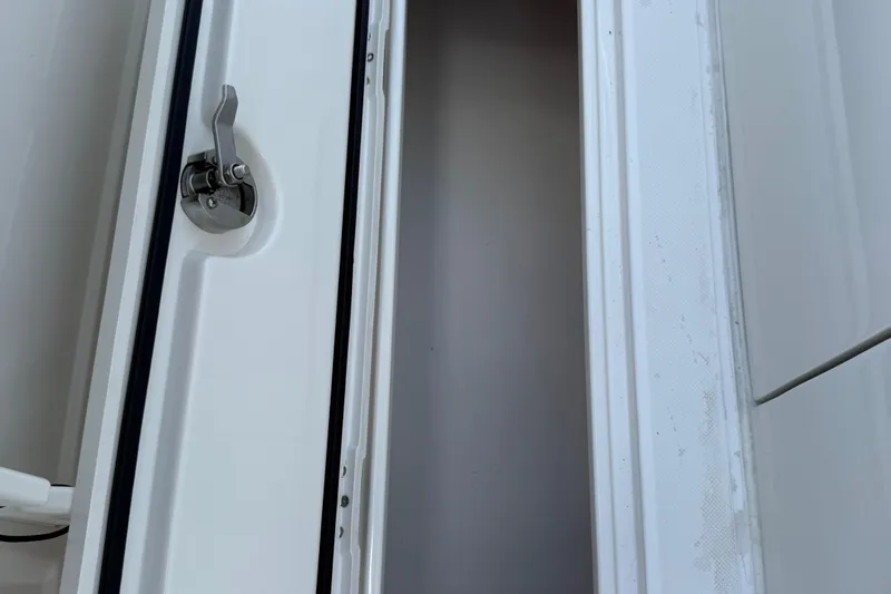  Yacht Photos Pics Boat storage compartment with metal latch on a 2014 Jupiter 30 FS.