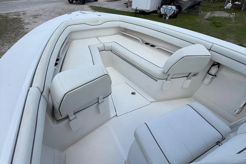  Yacht Photos Pics 2014 Jupiter 30 FS boat interior with white cushioned seating and storage compartments.