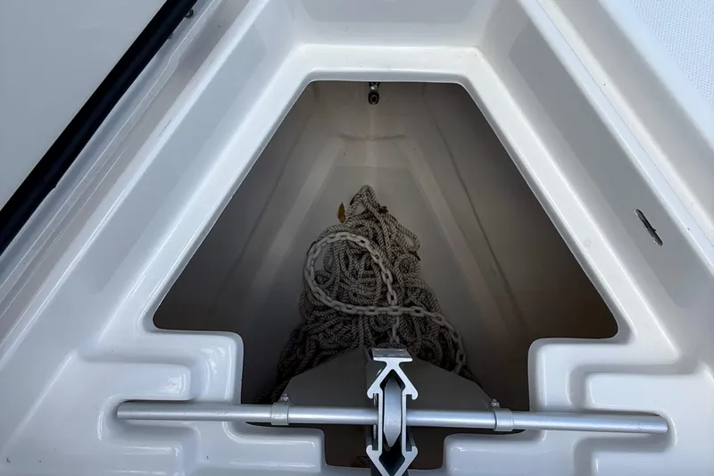  Yacht Photos Pics Anchor storage compartment on a 2014 Jupiter 30 FS boat, featuring coiled rope.